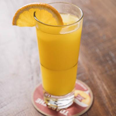 Mimosa cocktail garnished with orange