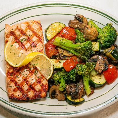 Grilled salmon fillet, with sauteed veggies and mushrooms.