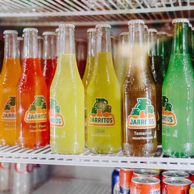 Soda bottles in the fridge.