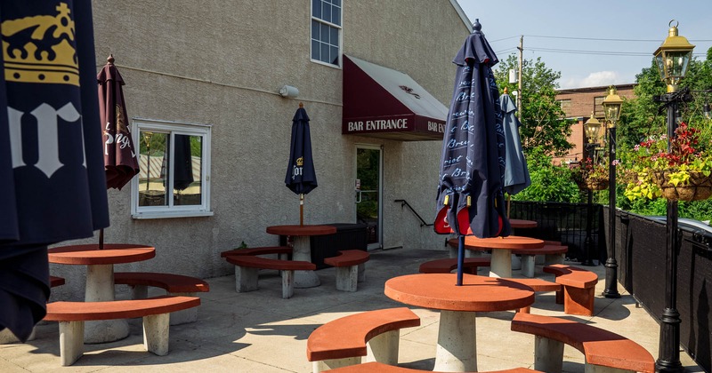 Outdoor seating area with red tables and parasols