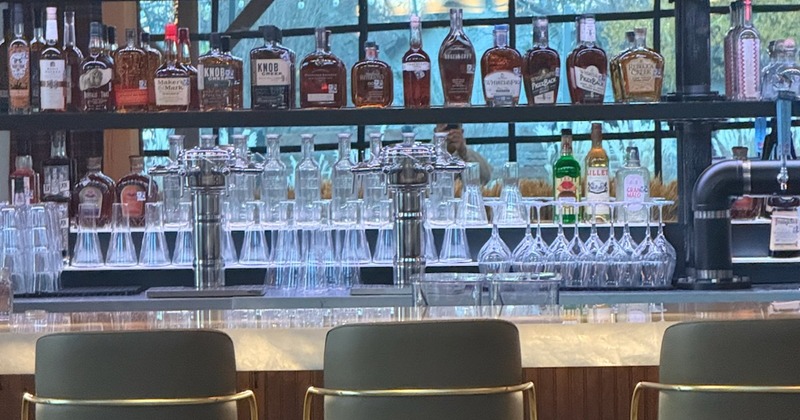 Bar shelves holding assorted liquor bottles and glassware