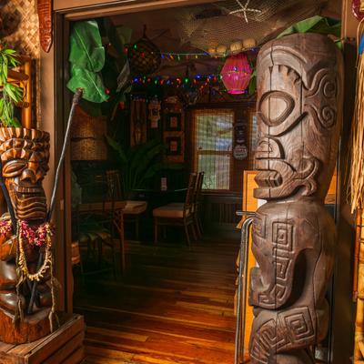 Interior, dining area, decorative tribal statues.
