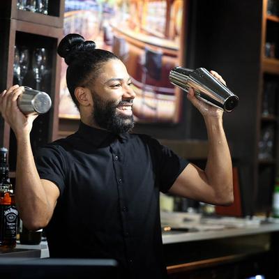 A person shaking a cocktail.