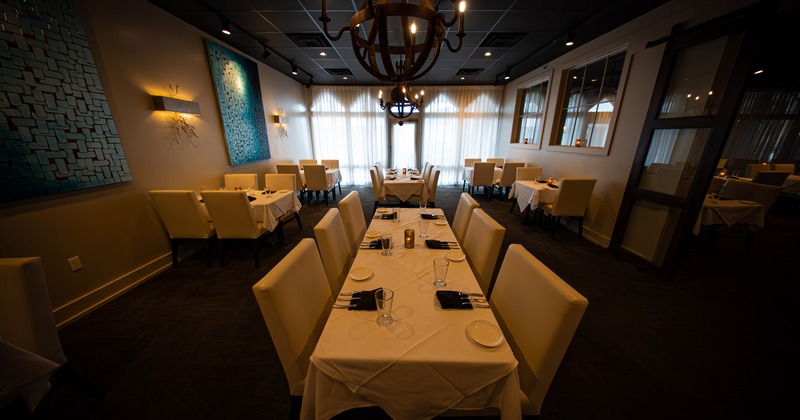 Specious and cozy private dining room with set tables, perfect for any occasion