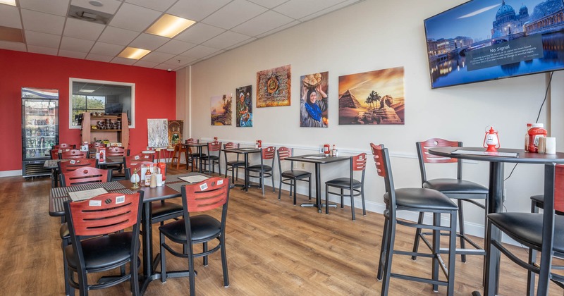 Dining area with big TV and pictures on the wall