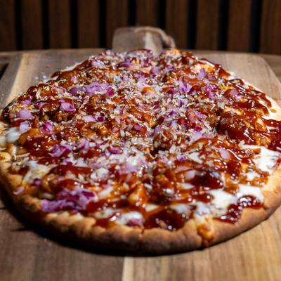BBQ chicken pizza topped with melted mozzarella cheese and BBQ sauce.