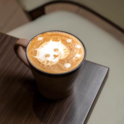 Latte with cat-themed latte art.
