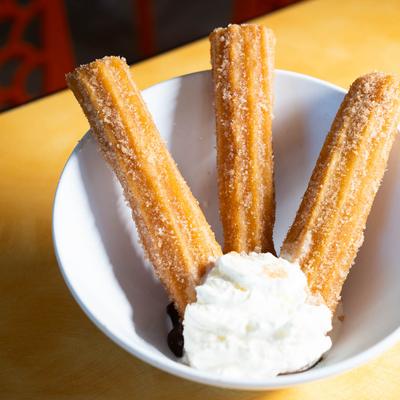 Churros served with homemade whipped cream.