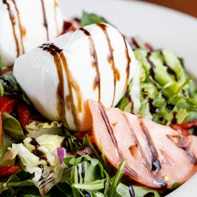 Burrata Salad, with mixed greens, arugula, peppers, onion, tomato, olive oil, and balsamic.