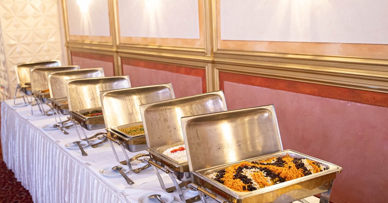 A table with food in chafing dishes