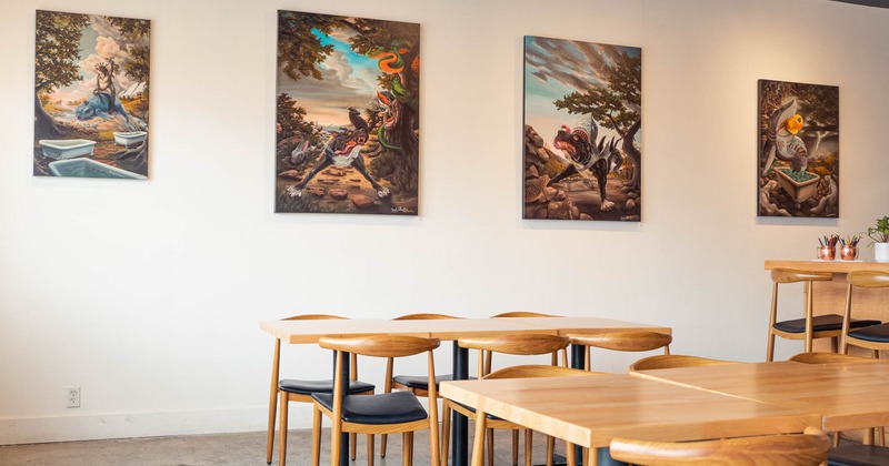 Interior, tables and chairs, paintings on a wall