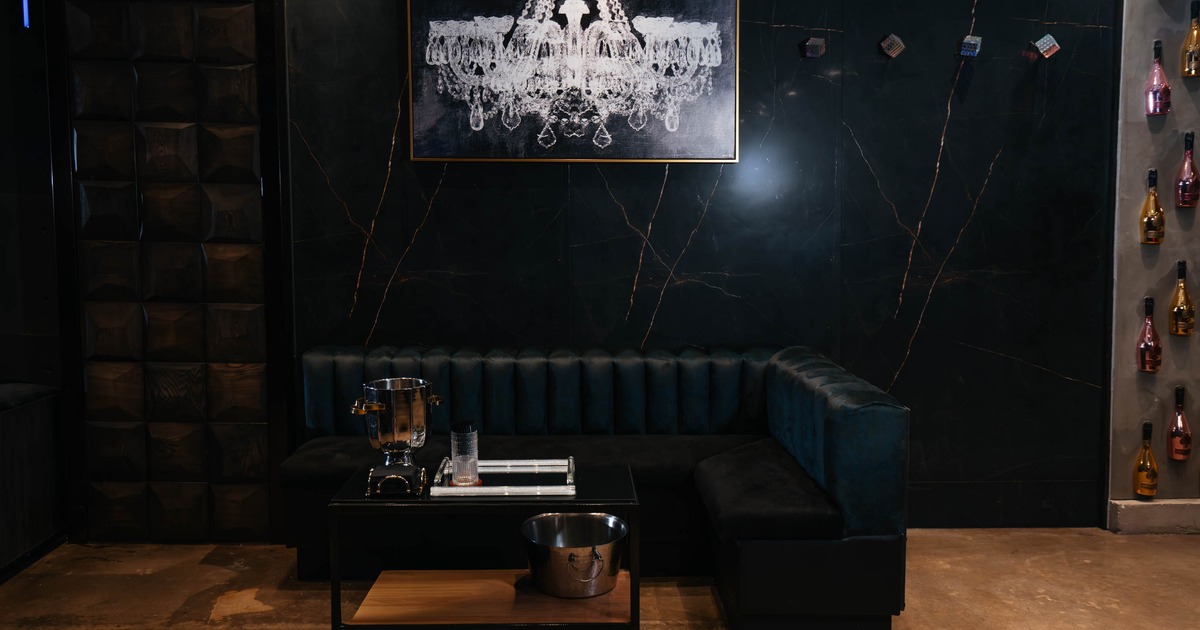 Interior, corner seating booth with coffee table, concrete flooring