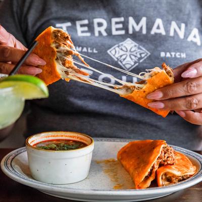 Customer eating birria tacos.