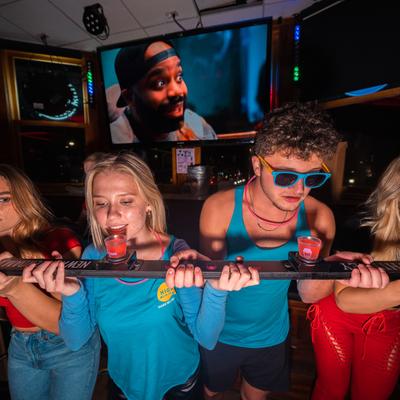 People drinking a group drink flight.