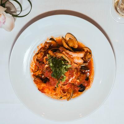 Seafood pasta in tomato sauce with basil.