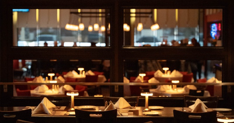 Elegantly set tables under warm lighting