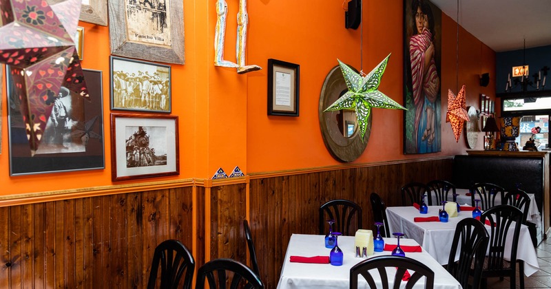 Set dining area, colorful hanging star decorations, vintage pictures and paintings on a wall