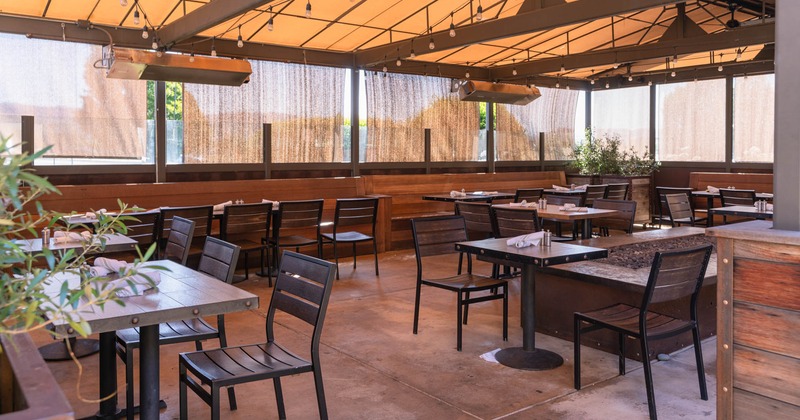 Outdoor, covered patio with tables and chairs
