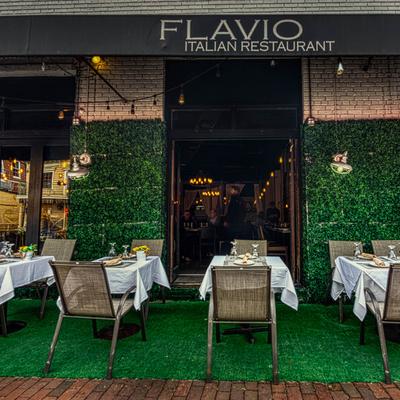 Exterior of Flavio Italian Restaurant featuring outdoor seating.