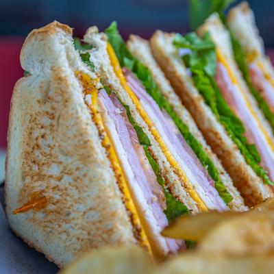 Close up of club sandwich with chips.