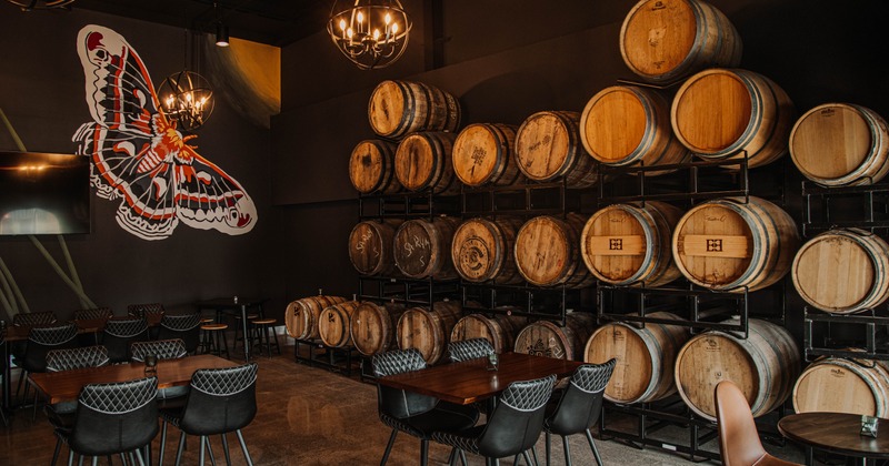 Seating room interior with mural art and barrel racks by a wall