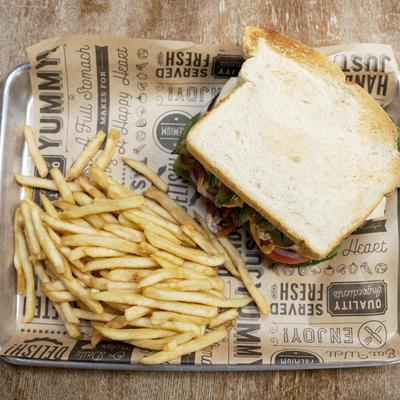 Top view of a tuna sandwich and fries.