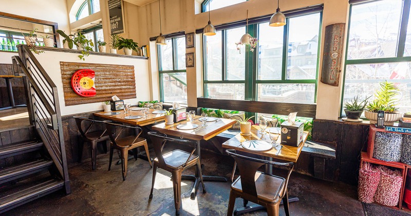 Interior, lined up tables and chairs by the windows