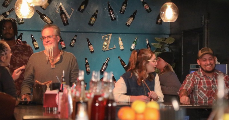 Bar, people, decorated wall behind