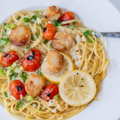 Pan seared scallops with linguine pasta.