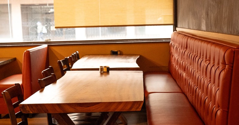 Interior, tables, chairs and red leather benches