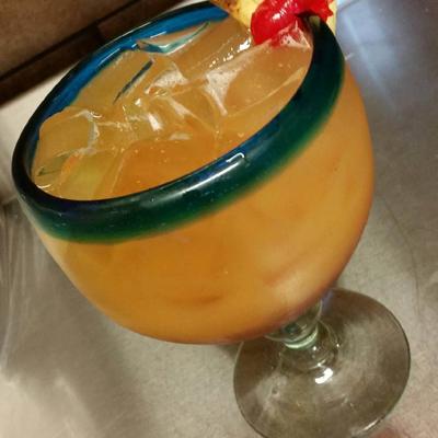 Margarita cocktail served in a traditional glass with a blue-rim.