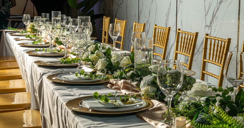Interior, long table set with tableware