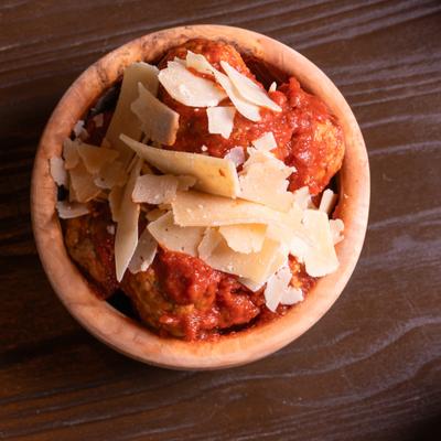 Side of meatballs topped with Parmesan.