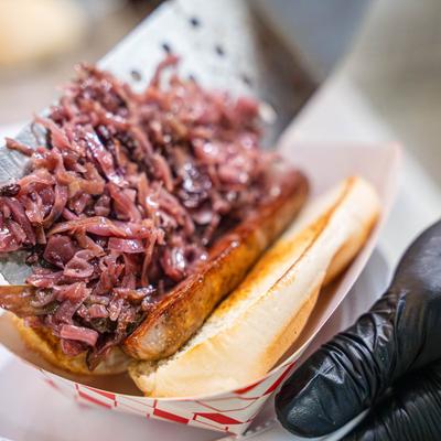 Sandwich with smoked sausage and red cabbage.