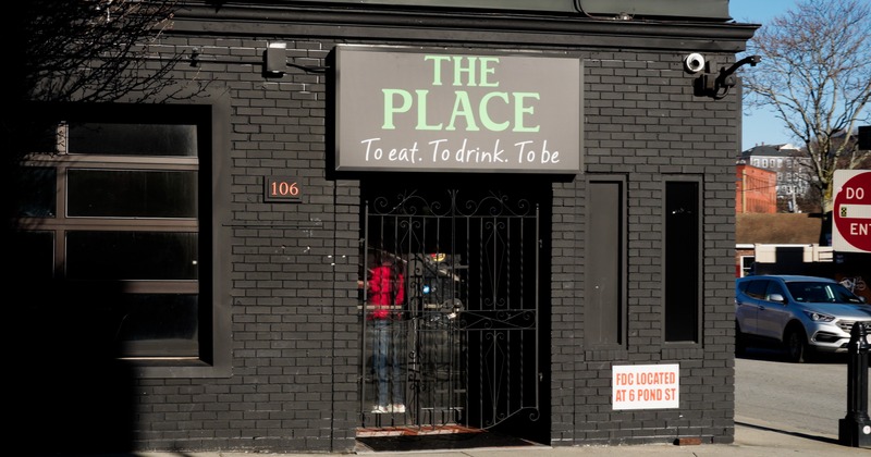 Exterior, front view to entrance and sign above