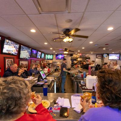 People seated at a lively bar counter.