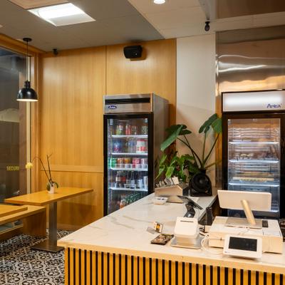 The serving counter and refrigerators.