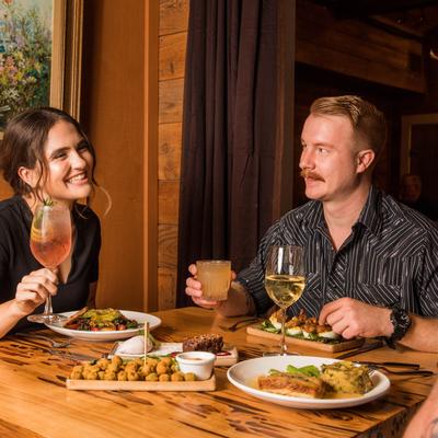 Customers sitting at table and eating food
