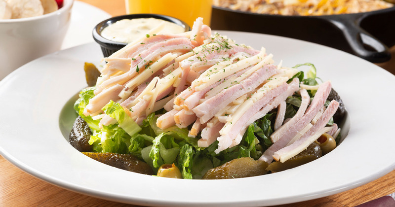 Sliced smoked meat and salad