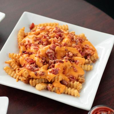 Loaded fries topped with cheese and bacon.