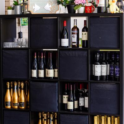 Various wine bottles on the shelf.