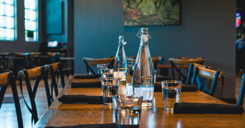 Table with bottles and glasses of water served