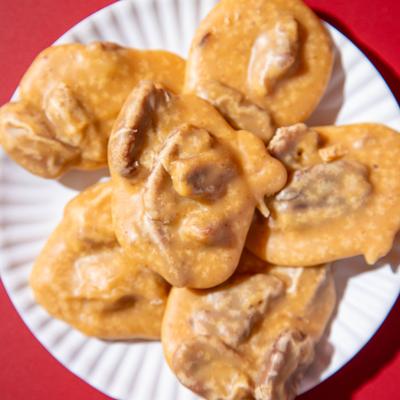 New Orleans-style pecan pralines on a white plate.