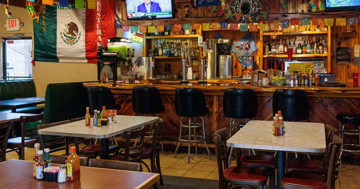 Mexican-style restaurant interior, dining tables near the bar