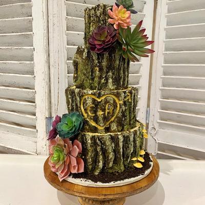 Four tier tree stump cake with floral decoration