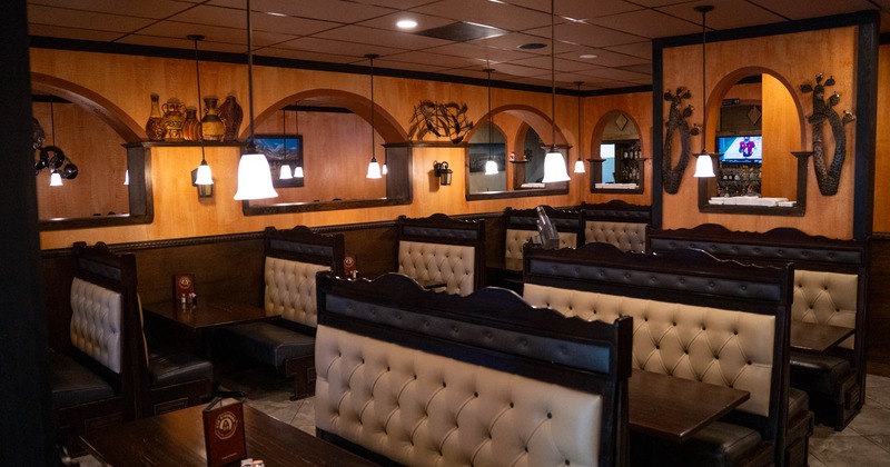 Interior, wide view of dining area, leather booths and tables