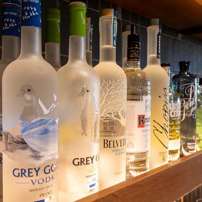 Vodka bottles on a shelf. Hand-crafted cocktails happy hour daily..