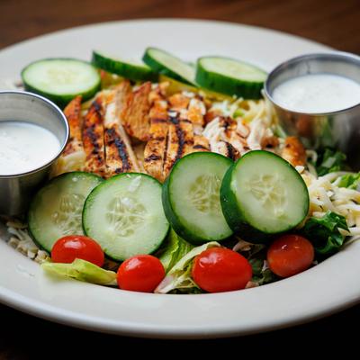 Grilled chicken salad with sauces.