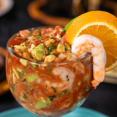 Shrimp cocktail with diced tomatoes, onions, jalapeños, cilantro, and avocado.