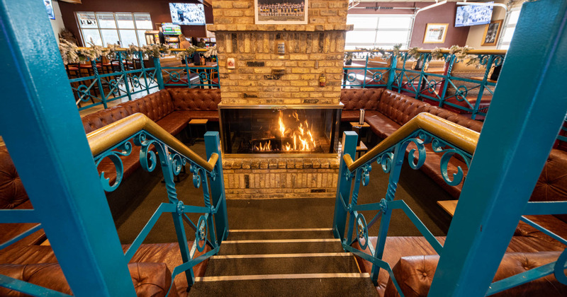 Interior, stairs that lead down to the middle area with the fireplace and seats